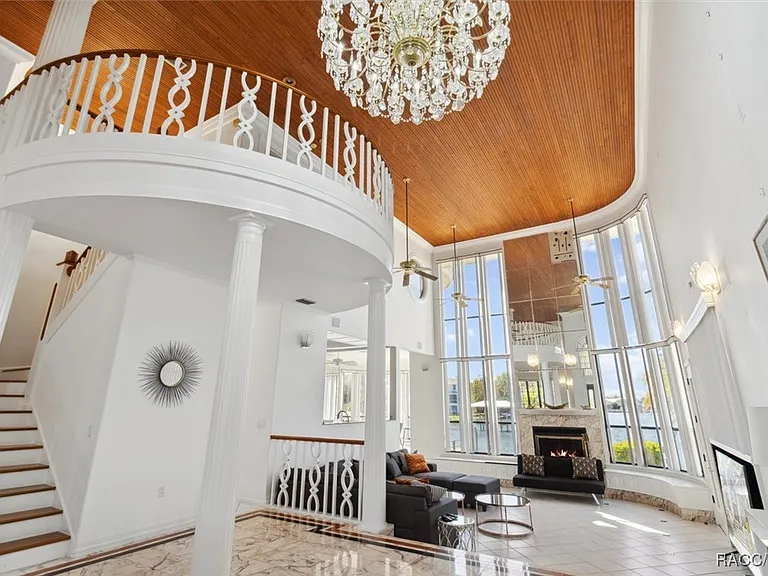 Two-story great room with chandelier and river views