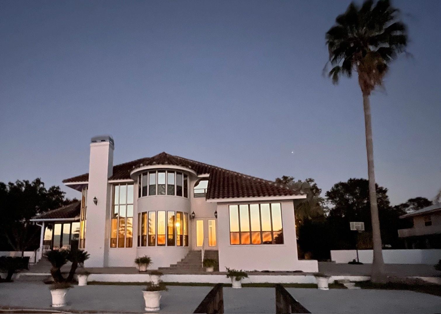 Aerial view of the waterfront home, pool, and dock